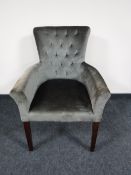 A contemporary armchair upholstered in an olive fabric
