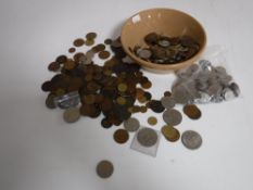 A bowl containing a large quantity of pre decimal and decimal British coinage, foreign coins,