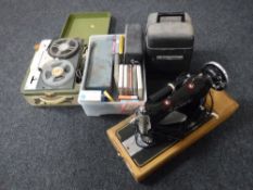 A cased vintage sewing machine, together with a Bell and Howell projector,