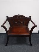 An Eastern mahogany carved armchair CONDITION REPORT: Typical light scuffs and