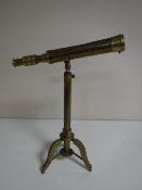 A brass telescope on tripod stand