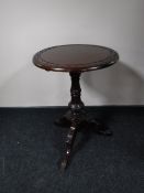 A Victorian style mahogany wine table on three way pedestal