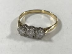 An 18ct gold three stone diamond ring, approximately 0.5ct, size O/P, 2.7g.
