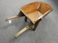 A wooden wheel barrow planter