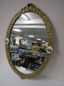 An oval gilt framed French wall mirror