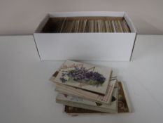 A box containing antique greetings card postcards