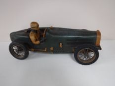 A wooden model of a vintage racing car