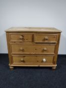 A stripped pine four drawer chest