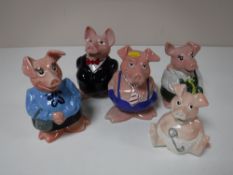 A collection of five NatWest pigs