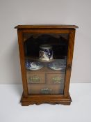 An Edwardian oak glazed door smoker's cabinet