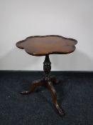 A Victorian style mahogany wine table on three way pedestal