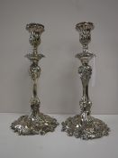 A pair of ornate Victorian silver plated candlesticks