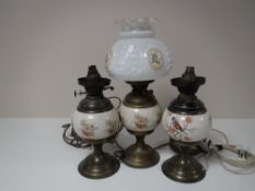 Two brass and china oil lamps with chimneys,