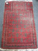 A fringed Afghan prayer rug