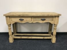 A reclaimed pine kitchen table fitted two drawers