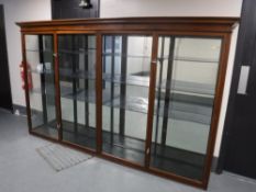 A late Victorian mahogany four door glazed shop cabinet, width 286 cm, height 173 cm,