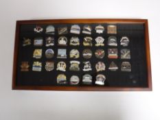 A display case of thirty eight enamelled badges related to shipping