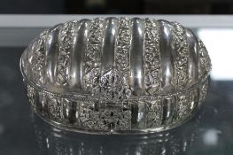 An ornate white metal table casket