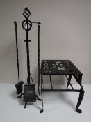 A large metal trivet and a four piece companion set on stand