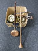 A box containing assorted brassware, clock movement, bellows, copper hunting horn, bed warming pan,