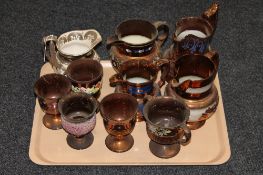 A tray containing five copper lustre jugs,