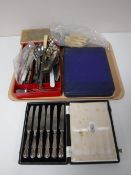 A tray containing a quantity of boxed and unboxed flatware