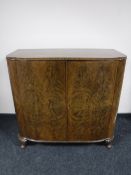 A figured walnut double door cabinet