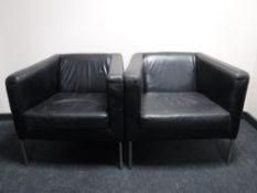 A set of four black leather armchairs on chrome legs