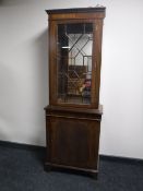 An inlaid mahogany Regency style display cabinet fitted a cupboard beneath
