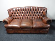 A brown button chesterfield three seater settee