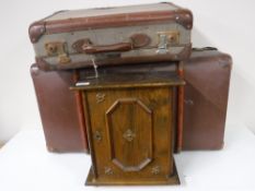 Two mid 20th century luggage cases together with a wall cabinet