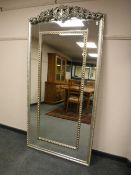 An ornate silvered mirror,