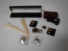 A pair of ivory glove stretchers, carved bone paper knife, badges and pins,