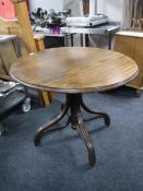 A circular bentwood pedestal table