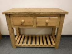 A reclaimed pine side table, fitted with two drawers,