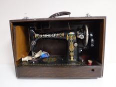 A cased mid twentieth century Singer sewing machine