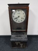 An oak cased Blick Time Recorders Limited clocking in machine