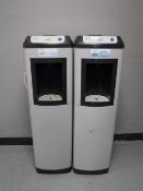 A pair of Oasis water coolers on stands