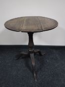 A Victorian oak pedestal occasional table