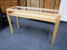 A contemporary two tier glass topped side table