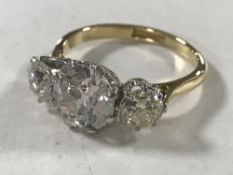 A superb 18ct gold and platinum three stone diamond ring,