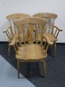 A set of three pine fiddle back armchairs