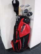 A Dunlop Sport gold bag containing a set of Peter Alice dual impact golf clubs