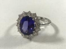 An 18ct white gold tanzanite diamond cluster ring, size N/O.