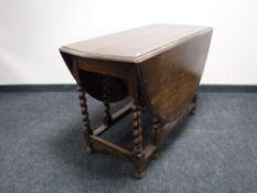An oak barley twist gate leg table