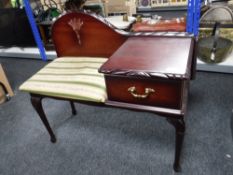 A reproduction mahogany telephone table