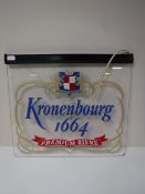 An illuminated Kronenbourg advertising sign