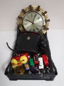 A basket containing a tin plate alarm clock, a desk clock, die cast vehicles,