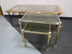 A contemporary glass top coffee table on metal legs,