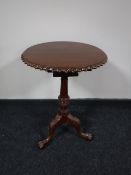 A Victorian style mahogany wine table on three way pedestal